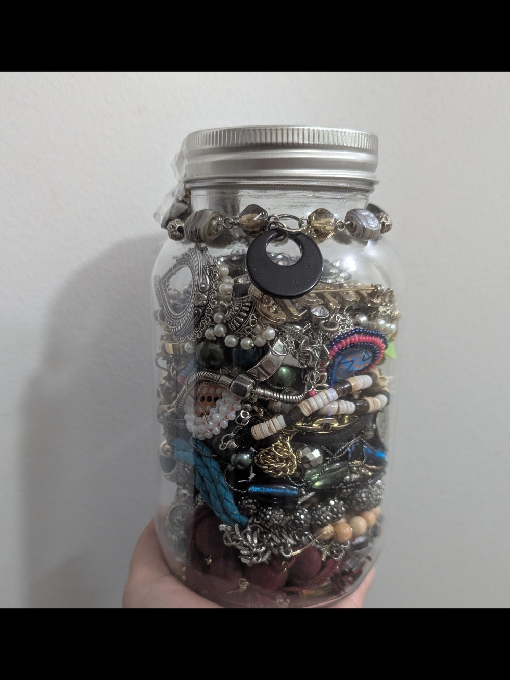 Assorted Silver and Multicolor Jewelry in Clear Glass Jar
